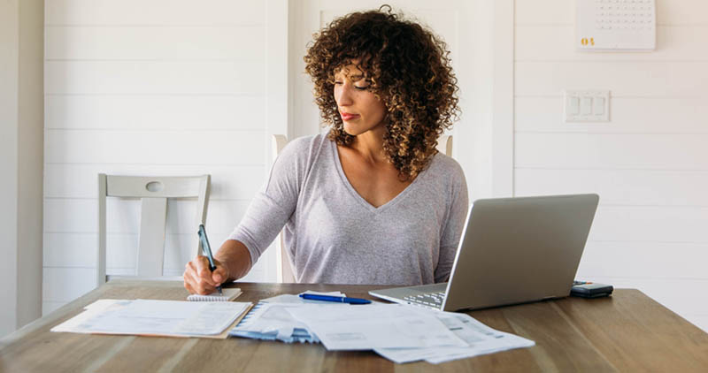 A freelancer working at home in a sunlit room