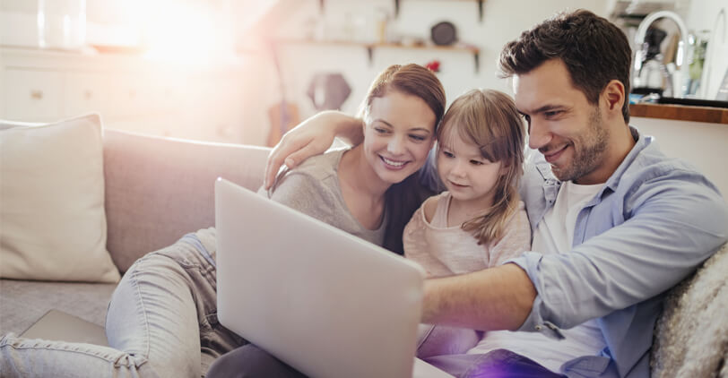 Family viewing laptop together