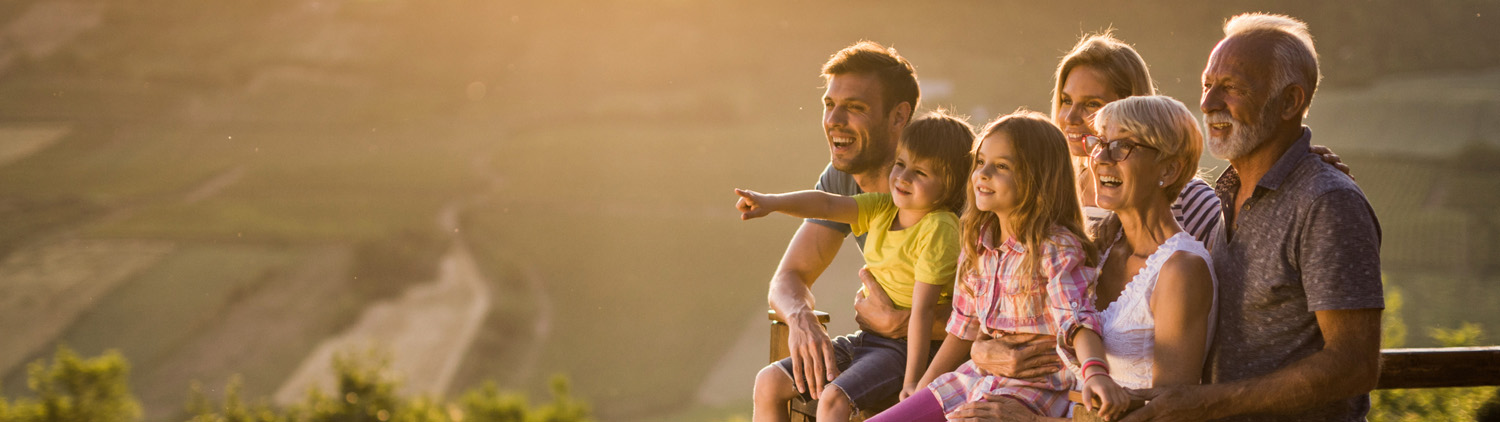 A multi-generational family outside at sunrise