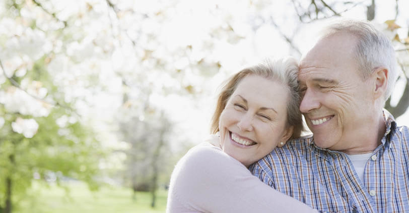 Couple smiling and hugging.