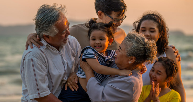 A happy multi-generational family at the beach