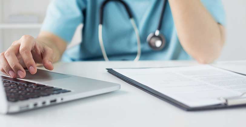 A healthcare provider enrolling on a laptop