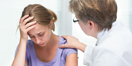 A physician counseling a patient