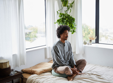 A man at home doing yoga.