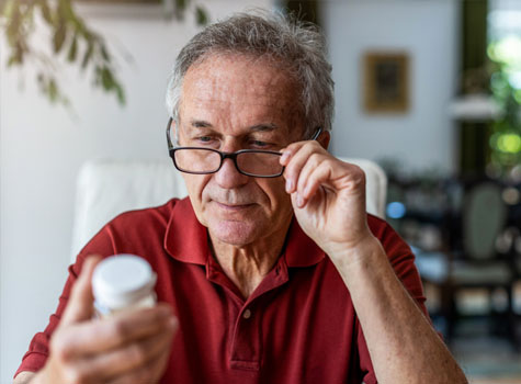 A senior man managing his prescription medications.