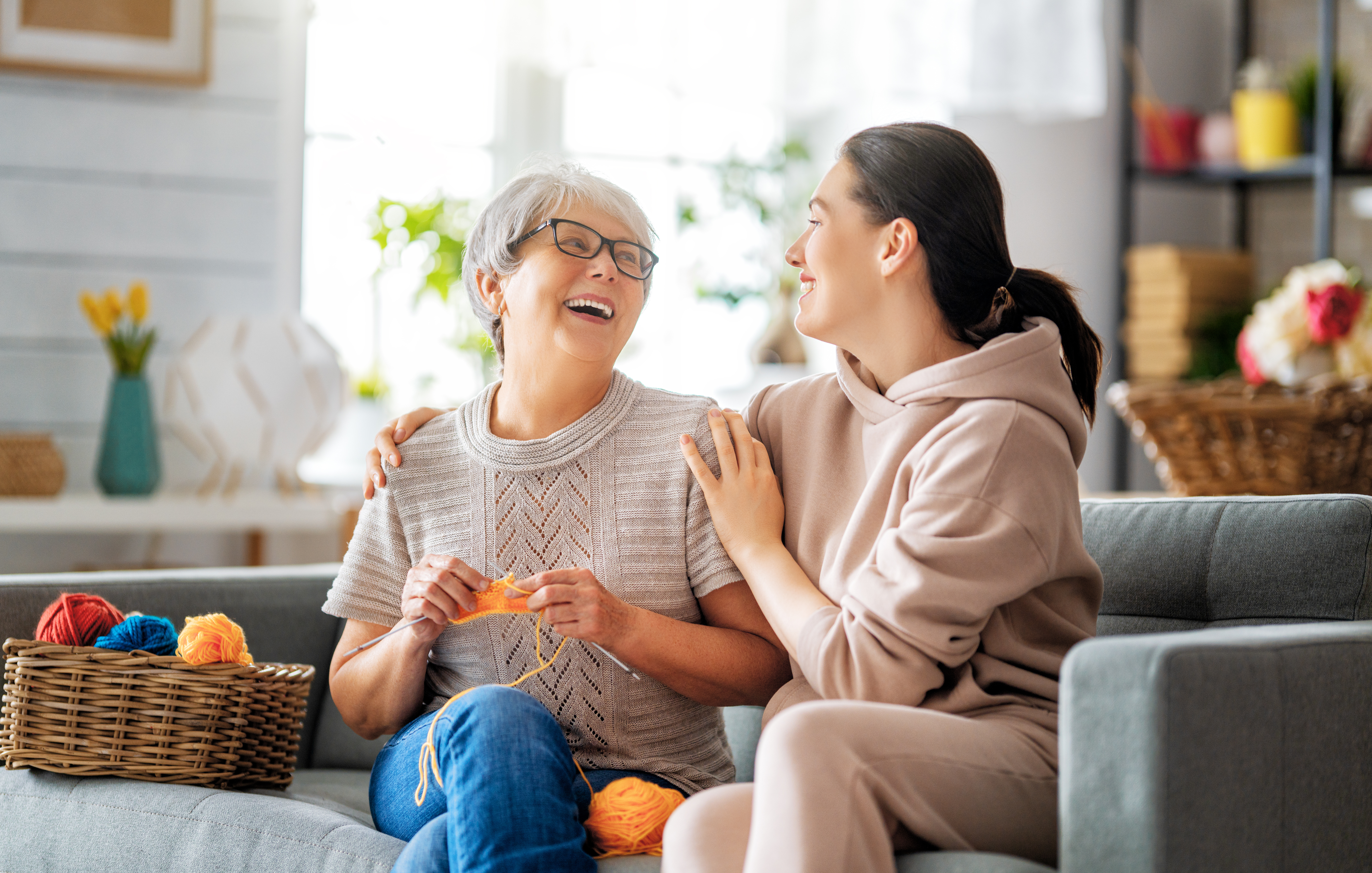 Older mother and her caregiver sitting together.