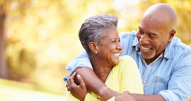 Senior Couple Relaxing In Autumn Landscape