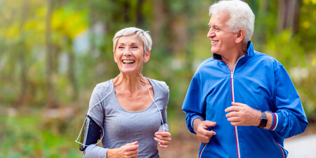 Senior couple jogging and smiling