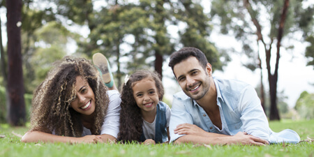 A happy family laying in the grass