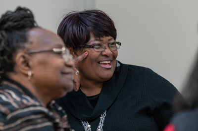 two woman in a group event