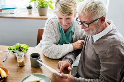 Happy elder couple looking at documents