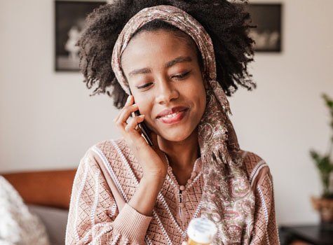 A sick woman calling the 24/7 Nurse Advice Line.