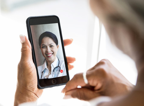 A woman having a doctor visit at home with MDLIVE