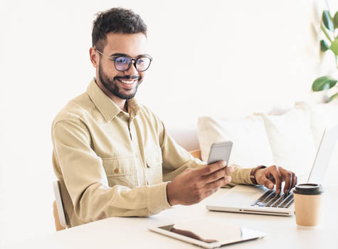 A man at a laptop researching medications.