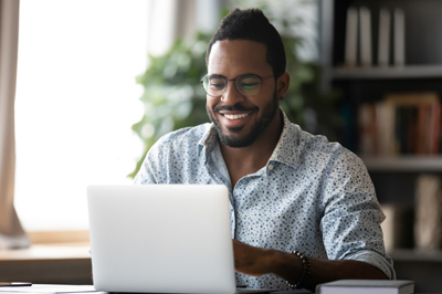 Happy man attending a webinar